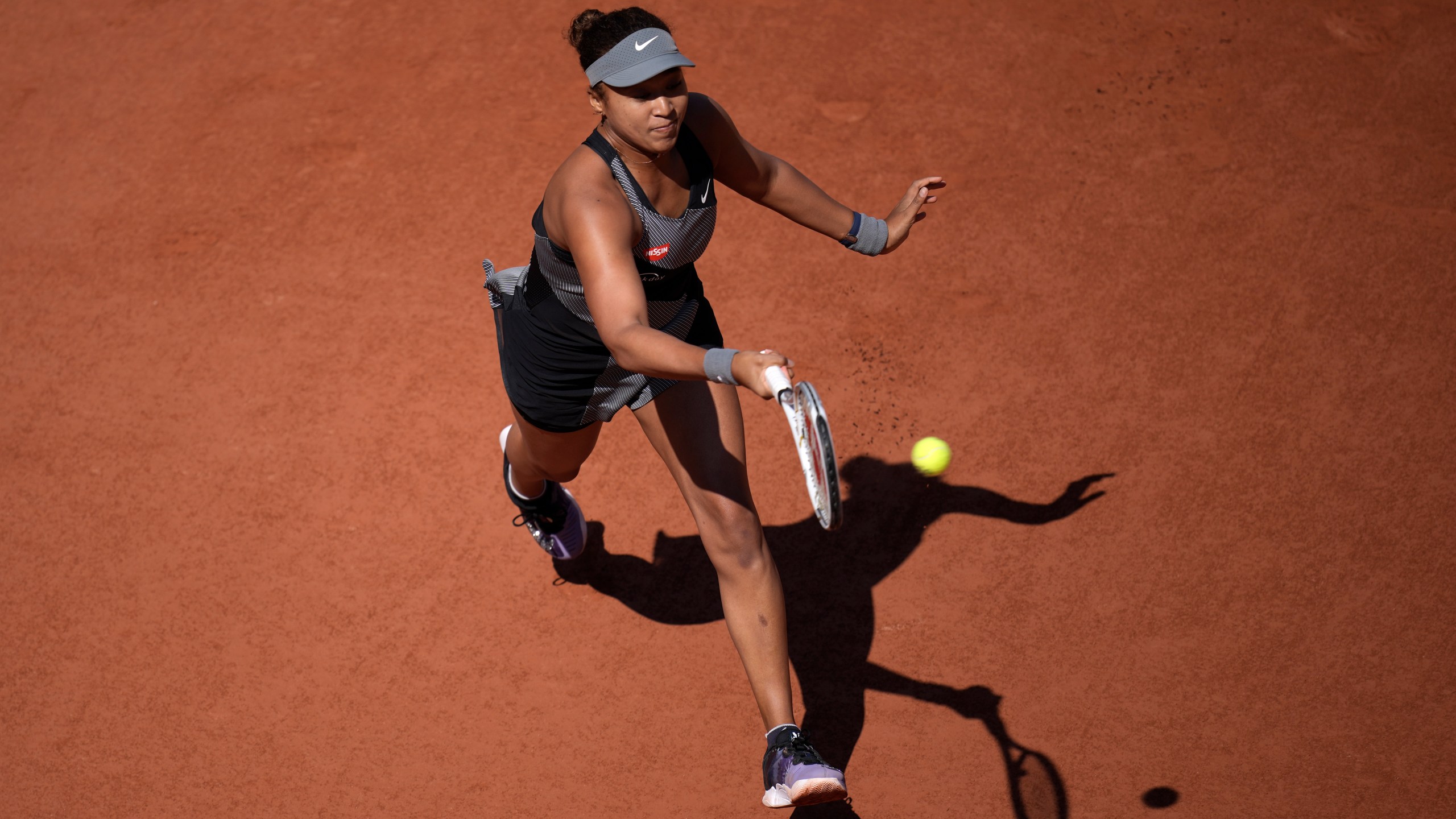 Japan's Naomi Osaka returns the ball to Romania's Patricia Maria Tig during their first round match at the Roland Garros stadium on May 30, 2021 in Paris. (Christophe Ena/Associated Press)