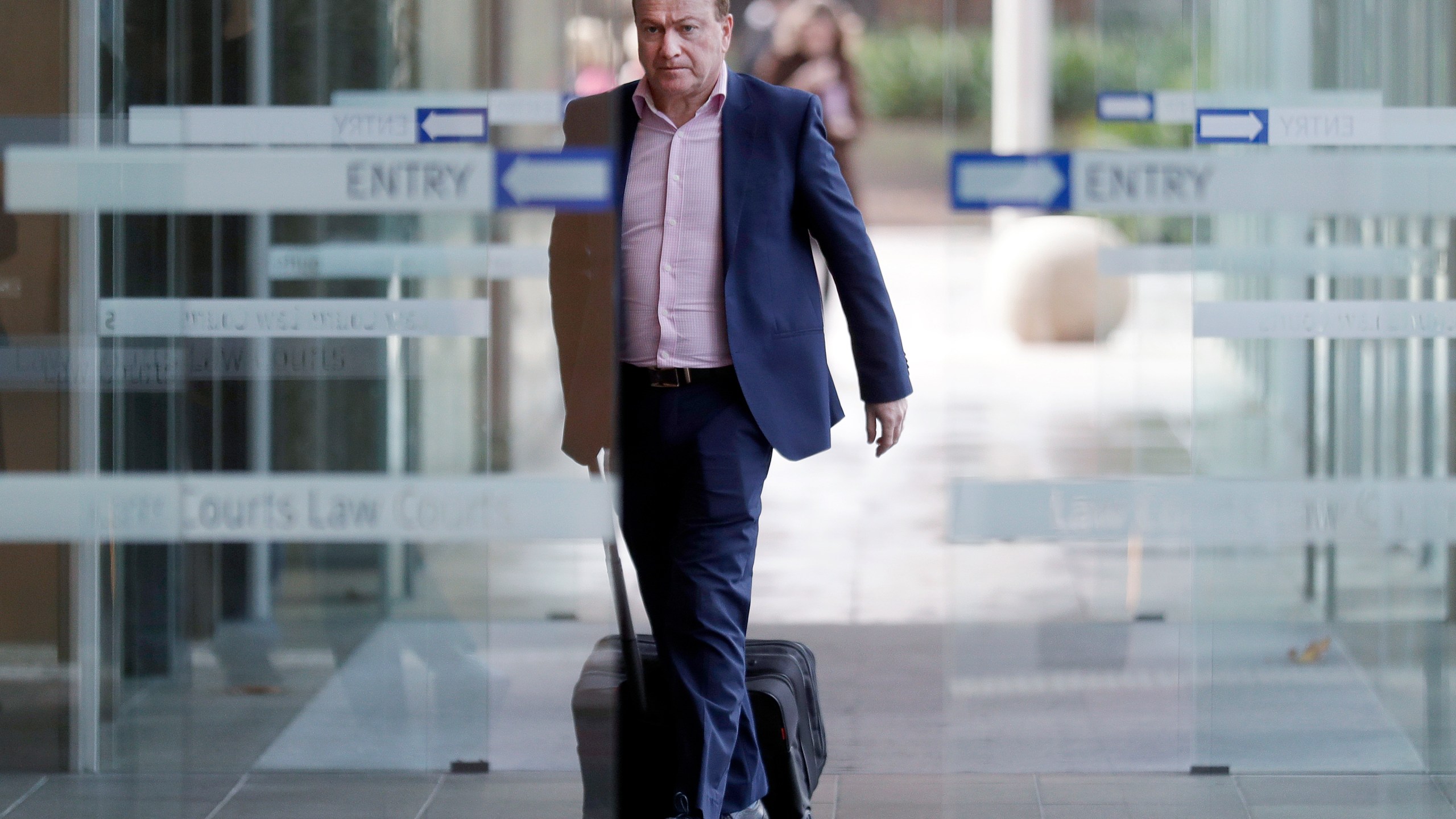 In this May 6, 2021, file photo, Andrew Cooper, founder and president of libertarian group LibertyWorks, arrives at Federal Court in Sydney. (AP Photo/Rick Rycroft, File)