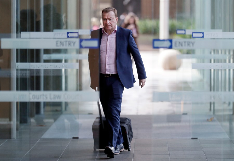 In this May 6, 2021, file photo, Andrew Cooper, founder and president of libertarian group LibertyWorks, arrives at Federal Court in Sydney. (AP Photo/Rick Rycroft, File)