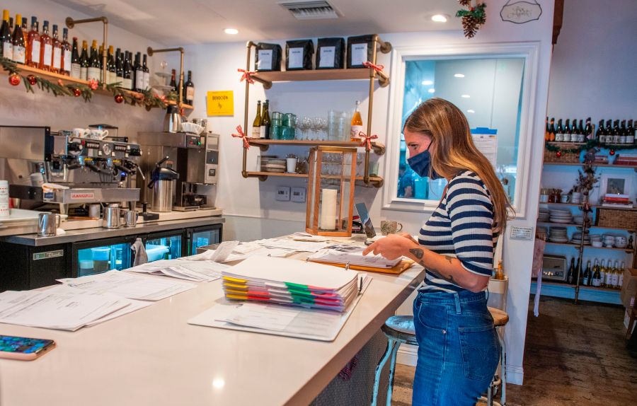 Sarah Bessade, owner of "La Loupiotte Kitchen", a restaurant in Los Angeles, works on her accounts in the restaurant's kitchen on Dec. 8, 2020. (VALERIE MACON/AFP via Getty Images)