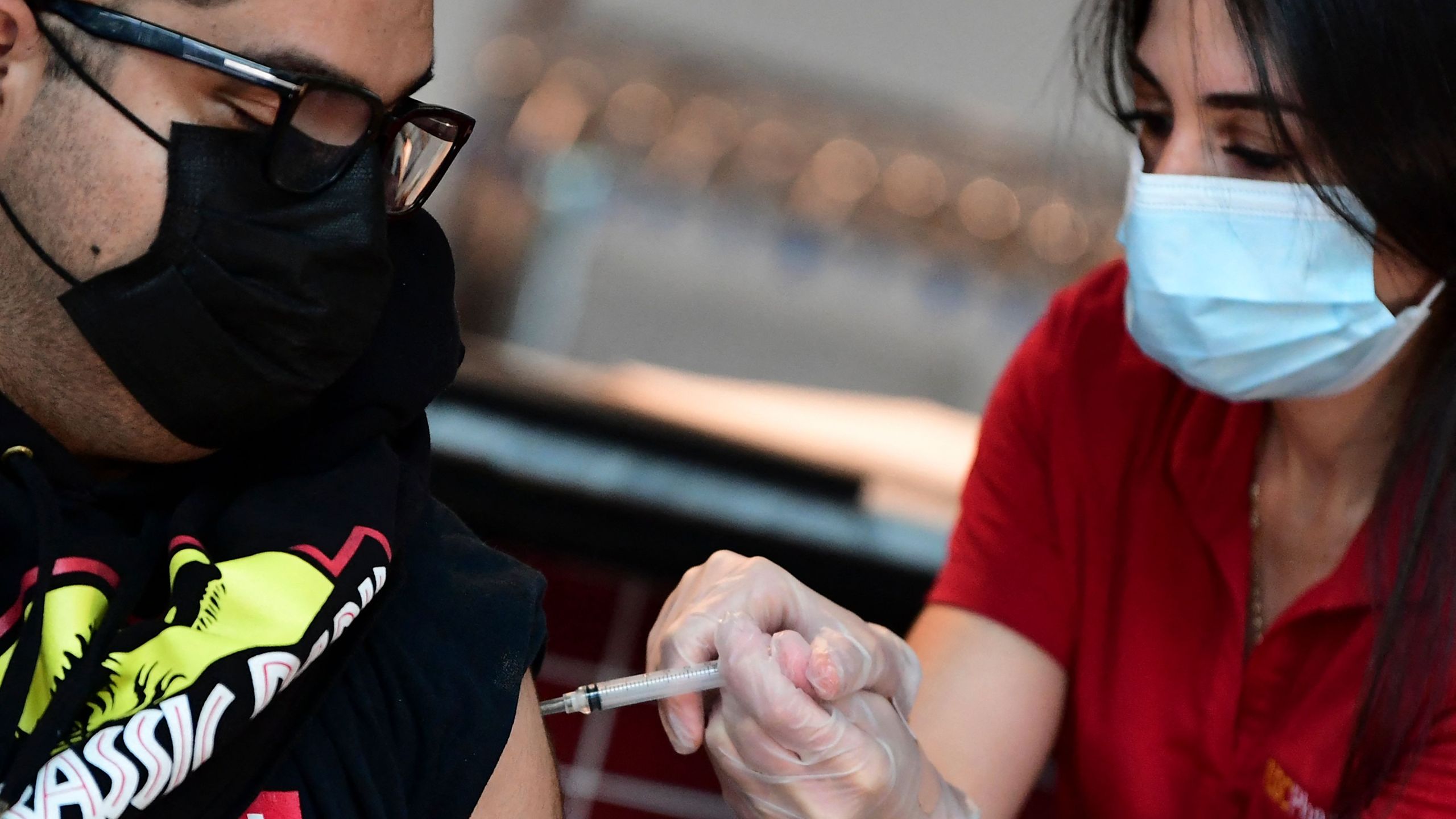 Ricardo Sierra receives his Johnson & Johnson COVID-19 vaccine administered by pharmacist Michelle Hormozia on May 7, 2021 at a vaccination clinic setup by Los Angeles Football Club. (FREDERIC J. BROWN/AFP via Getty Images)