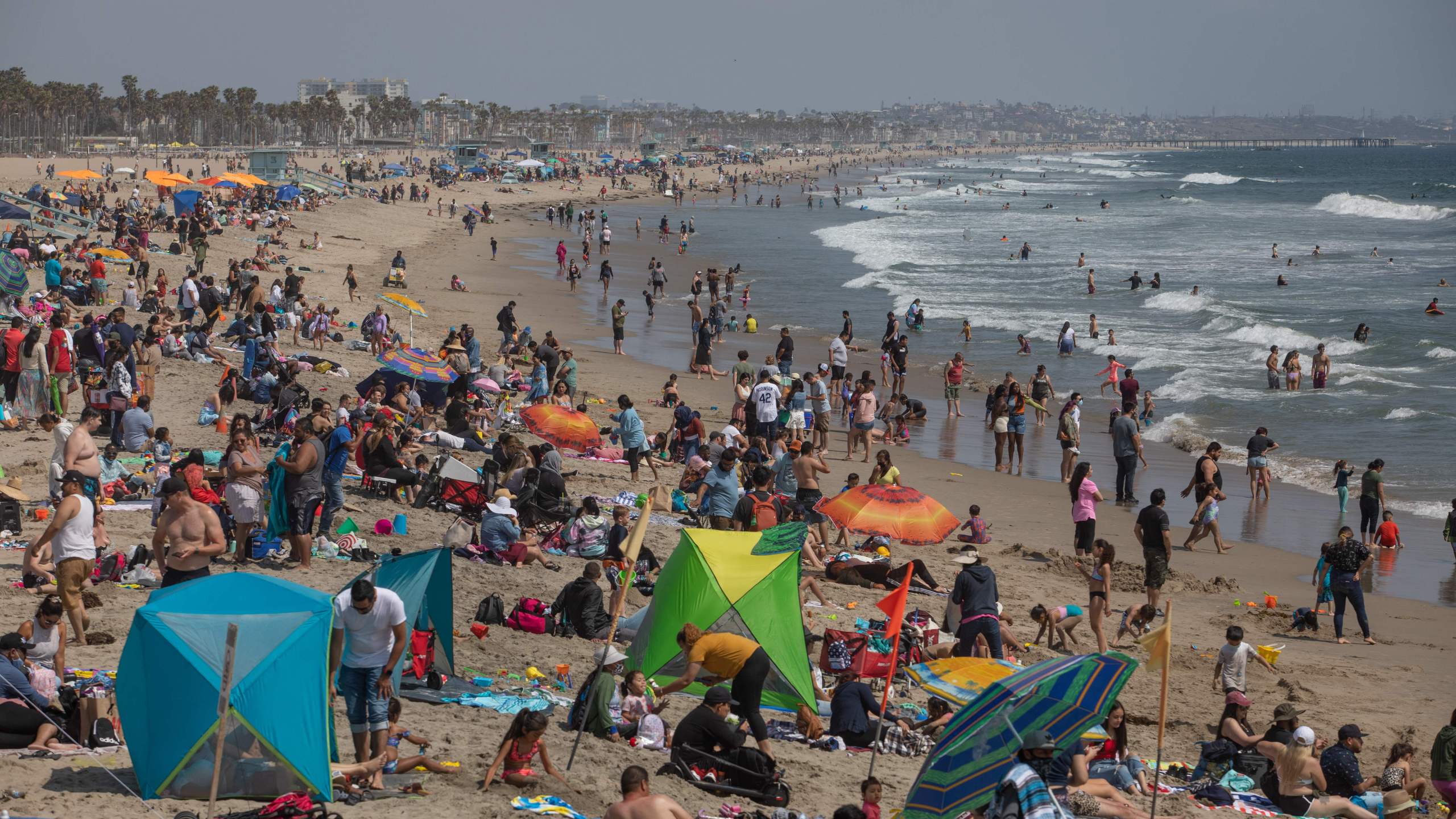 People enjoy a day at the beach ahead of Memorial Day in Santa Monica, California on May 29, 2021. (Photo by Apu GOMES / AFP) (Photo by APU GOMES/AFP via Getty Images)