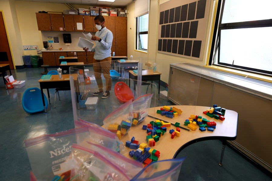 Bryant Elementary School kindergarten teacher Chris Johnson sets up his classroom on April 09, 2021 in San Francisco, California. (Justin Sullivan/Getty Images)