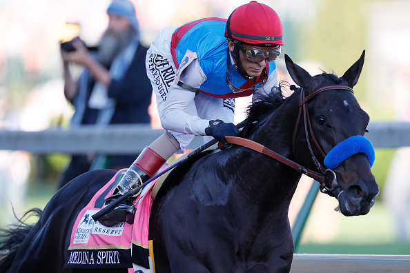 Medina Spirit #8, ridden by jockey John Velazquez, leads the field to the first turn during the 147th running of the Kentucky Derby at Churchill Downs on May 01, 2021 in Louisville, Kentucky. (Sarah Stier/Getty Images)