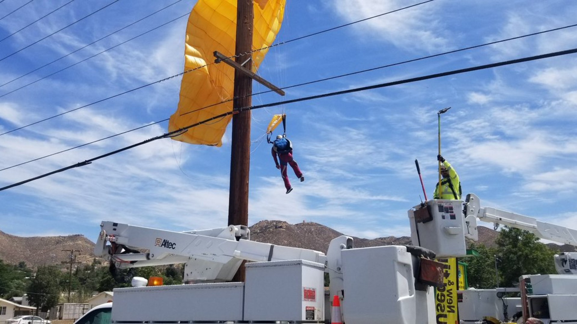 An apparent skydiver was rescued after his chute became stuck on power lines in Lake Elsinore on May 25, 2021. (Riverside County Fire Department)