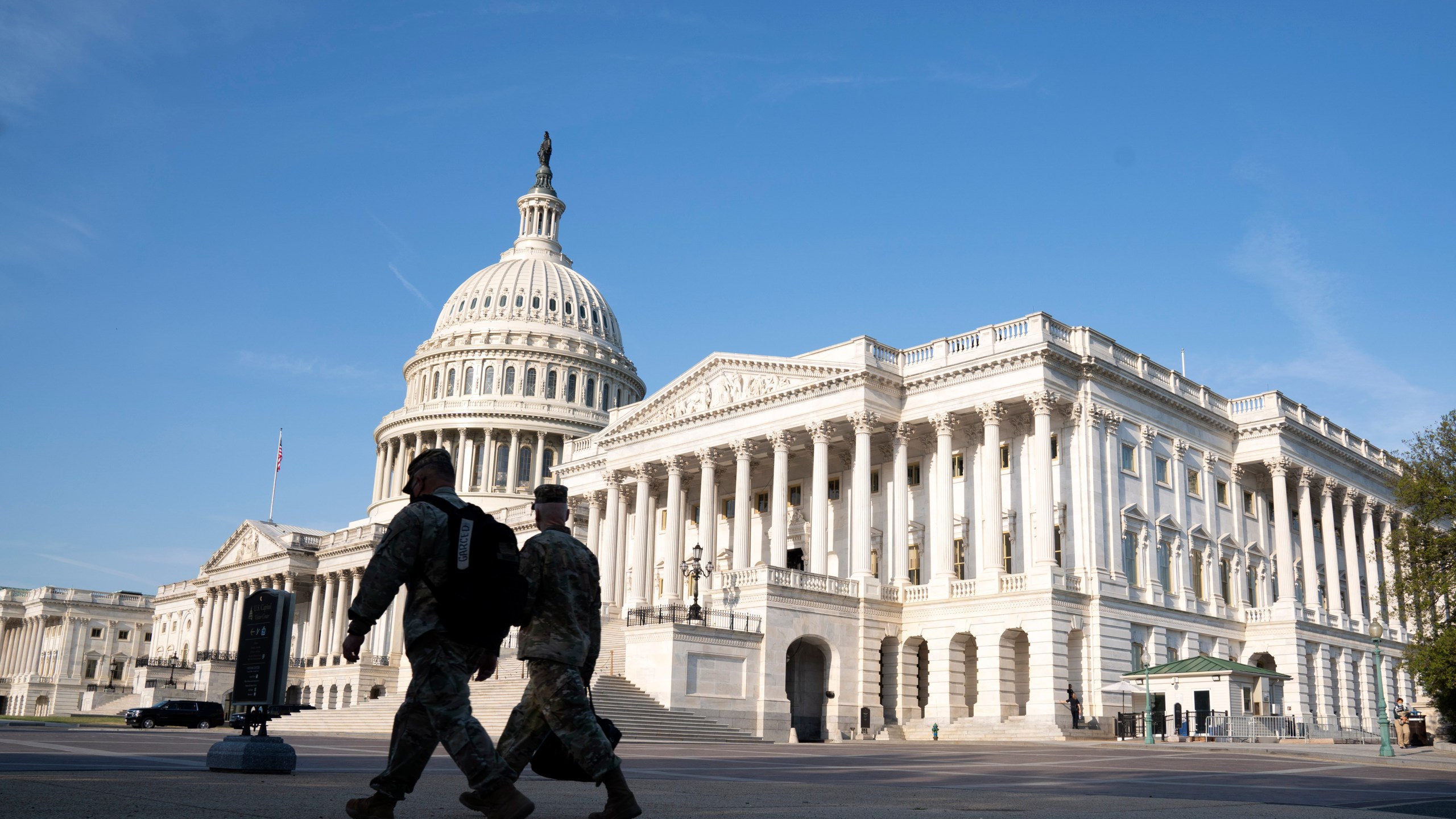 The U.S. Capitol is seen as national guard members pass by on Capitol Hill in Washington, Thursday, May 20, 2021. The House voted to create an independent commission on the deadly Jan. 6 insurrection at the U.S. Capitol, sending the legislation to an uncertain future in the Senate. (AP Photo/Jose Luis Magana)