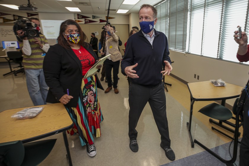 Teachers union President Cecily Myart-Cruz, left, and L.A. schools Supt. Austin Beutner inspect COVID-19 safety preparations at Panorama High School in March. Beutner had wanted a longer school year, but the union opposed it based on a survey of members.(Irfan Khan / Los Angeles Times)