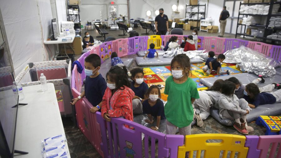 Young unaccompanied migrants, from ages 3 to 9, watch television inside a playpen at the U.S. Customs and Border Protection facility in Donna, Texas, the main detention center for unaccompanied children in the Rio Grande Valley. (Dario Lopez-Mills / Associated Press)