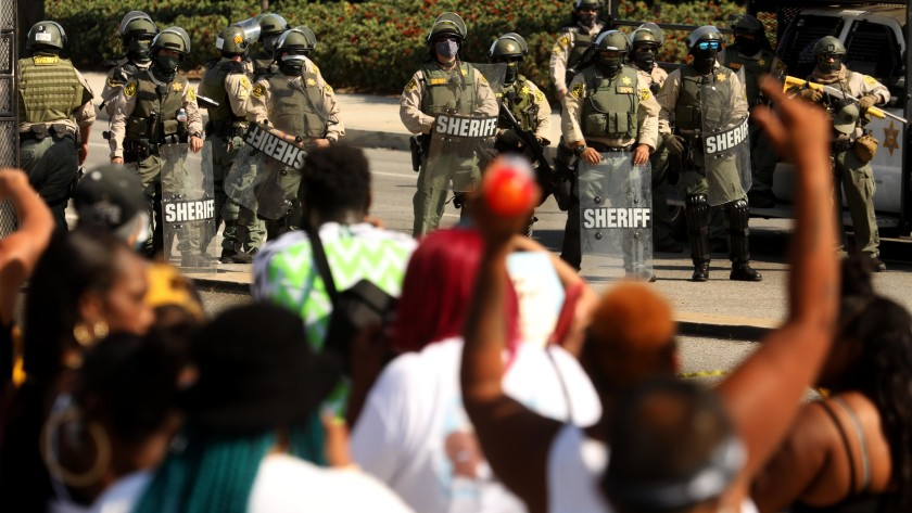 Protesters shout at sheriff’s deputies near the South Los Angeles sheriff’s station at a September 2020 protest after the deputy shooting of Dijon Kizzee. (Genaro Molina / Los Angeles Times)