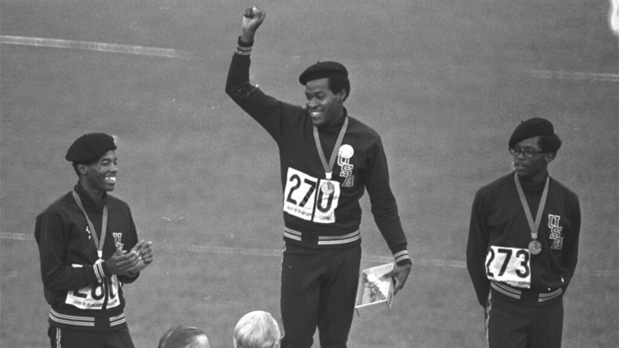 United States runners Larry James, left, Lee Evans, center, and Ron Freeman are shown after receiving their medals for the 400-meter race at the Mexico City Games in Mexico City, in this Oct. 18, 1968, file photo. (AP Photo/File)