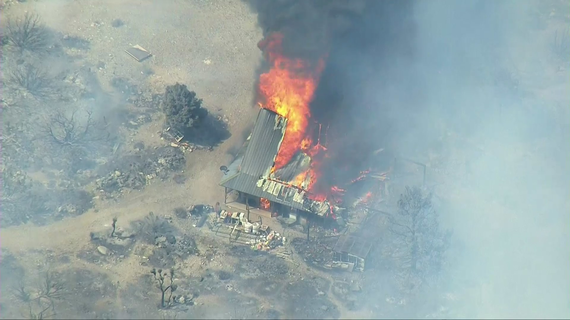 A structure burns in the Pine Fire outside Pinon Hills in the Antelope Valley on May 12, 2021. (KTLA)