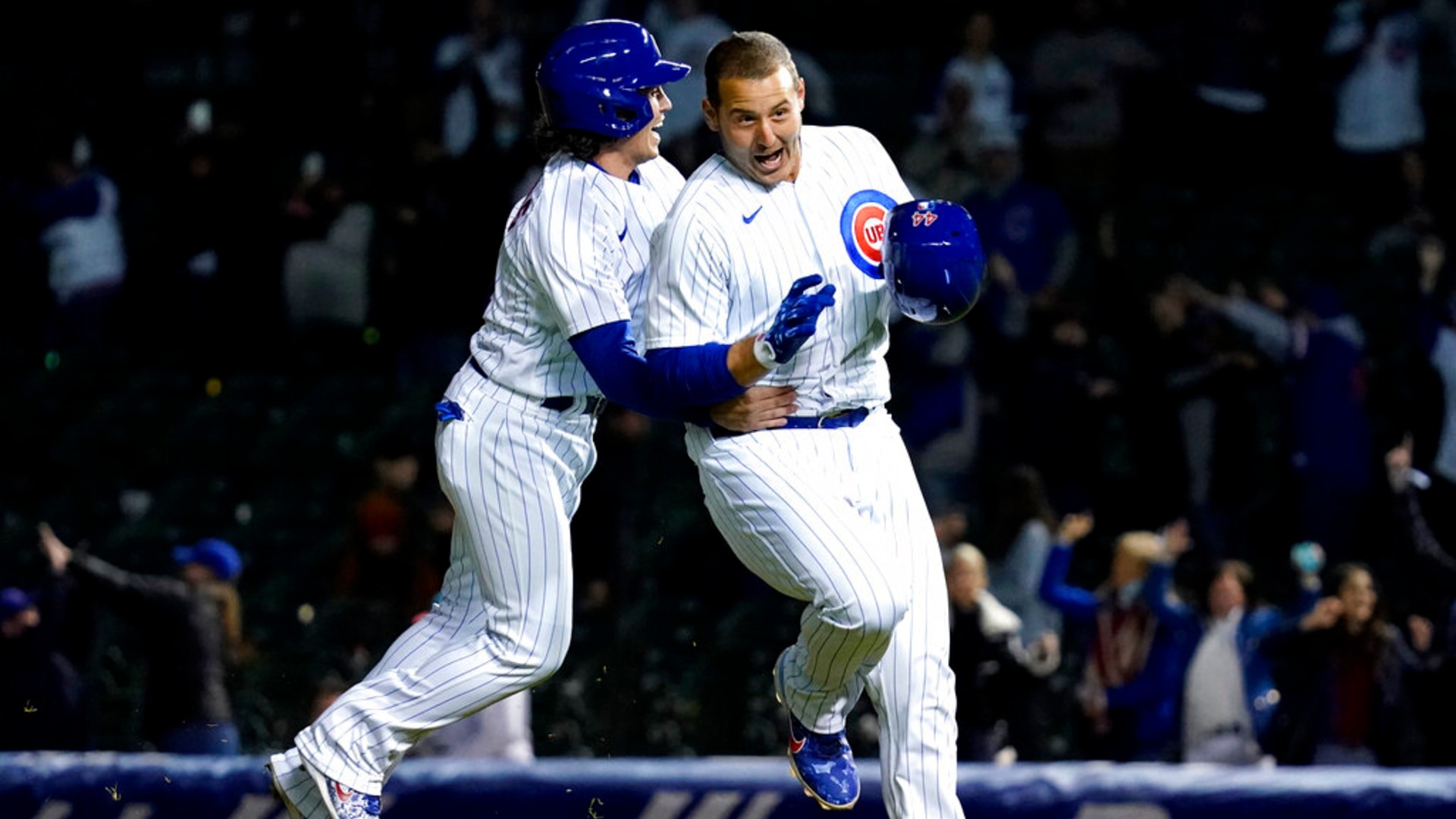 Chicago Cubs' Tony Wolters, left, congratulates Anthony Rizzo, who drove in the winning run in the 11th inning of a baseball game against the Los Angeles Dodgers in Chicago, Wednesday, May 5, 2021. The Cubs won 6-5. (AP Photo/Nam Y. Huh)