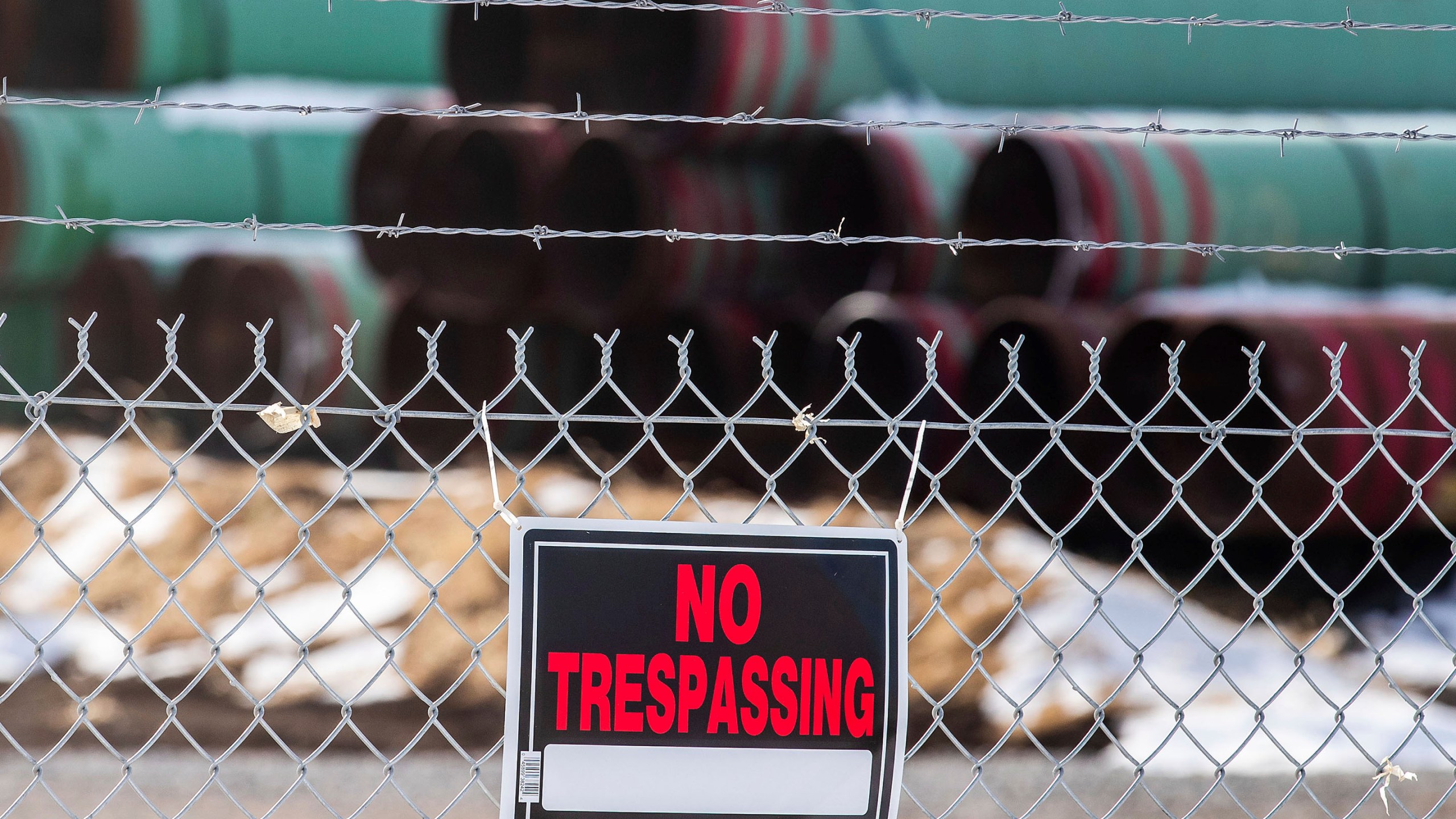 In this Dec. 18, 2020 photo, pipes to be used for the Keystone XL pipeline are stored in a field near Dorchester, Neb. (Chris Machian /Omaha World-Herald via AP)