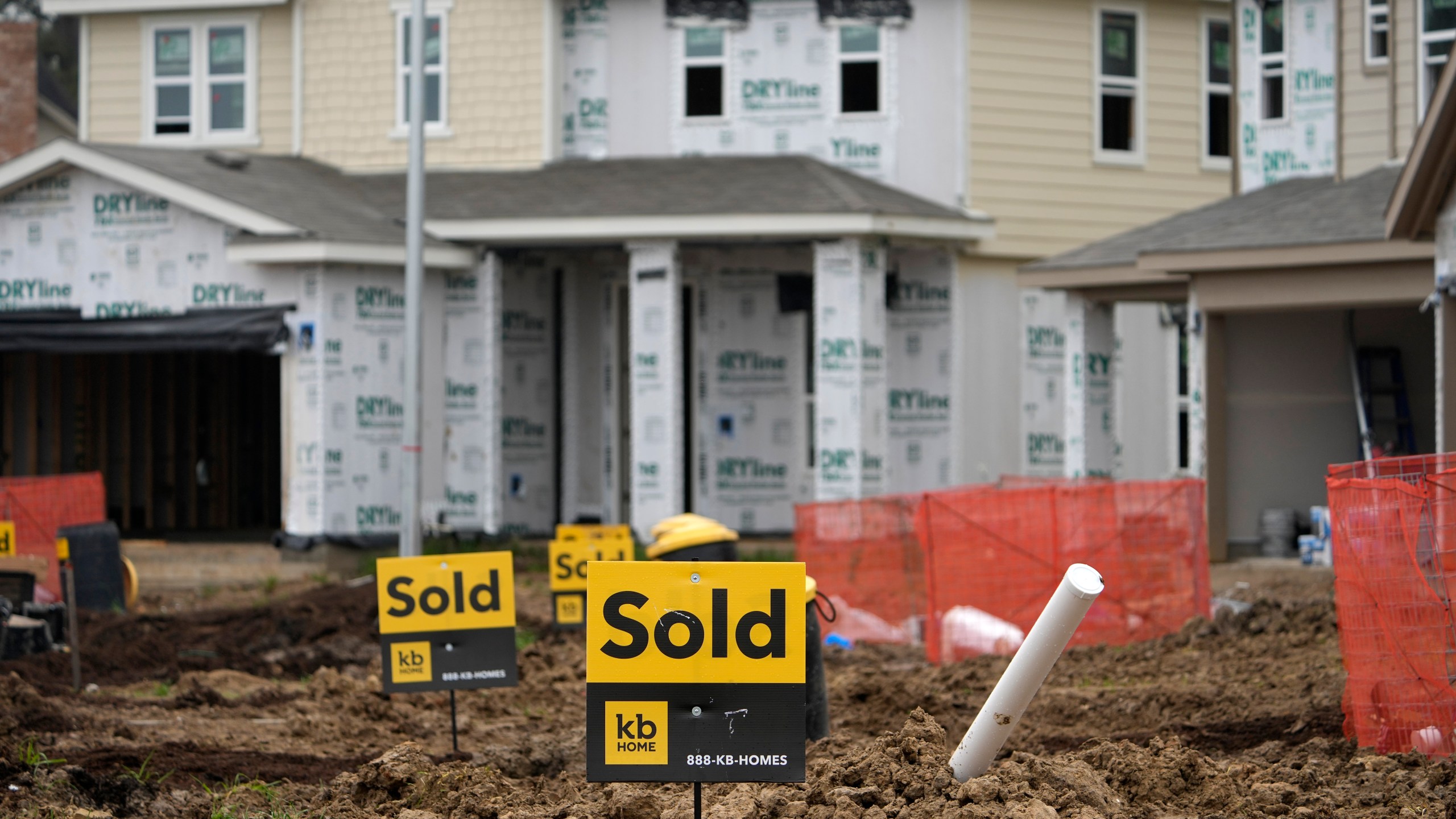 Sold signs stand in front of new homes under construction Monday, March 15, 2021, in Houston. Sales of new homes fell a bigger-than-expected 5.9% in April, a drop that analysts blamed in part on soaring home prices. (AP Photo/David J. Phillip)