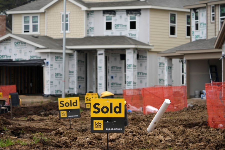 Sold signs stand in front of new homes under construction Monday, March 15, 2021, in Houston. Sales of new homes fell a bigger-than-expected 5.9% in April, a drop that analysts blamed in part on soaring home prices. (AP Photo/David J. Phillip)