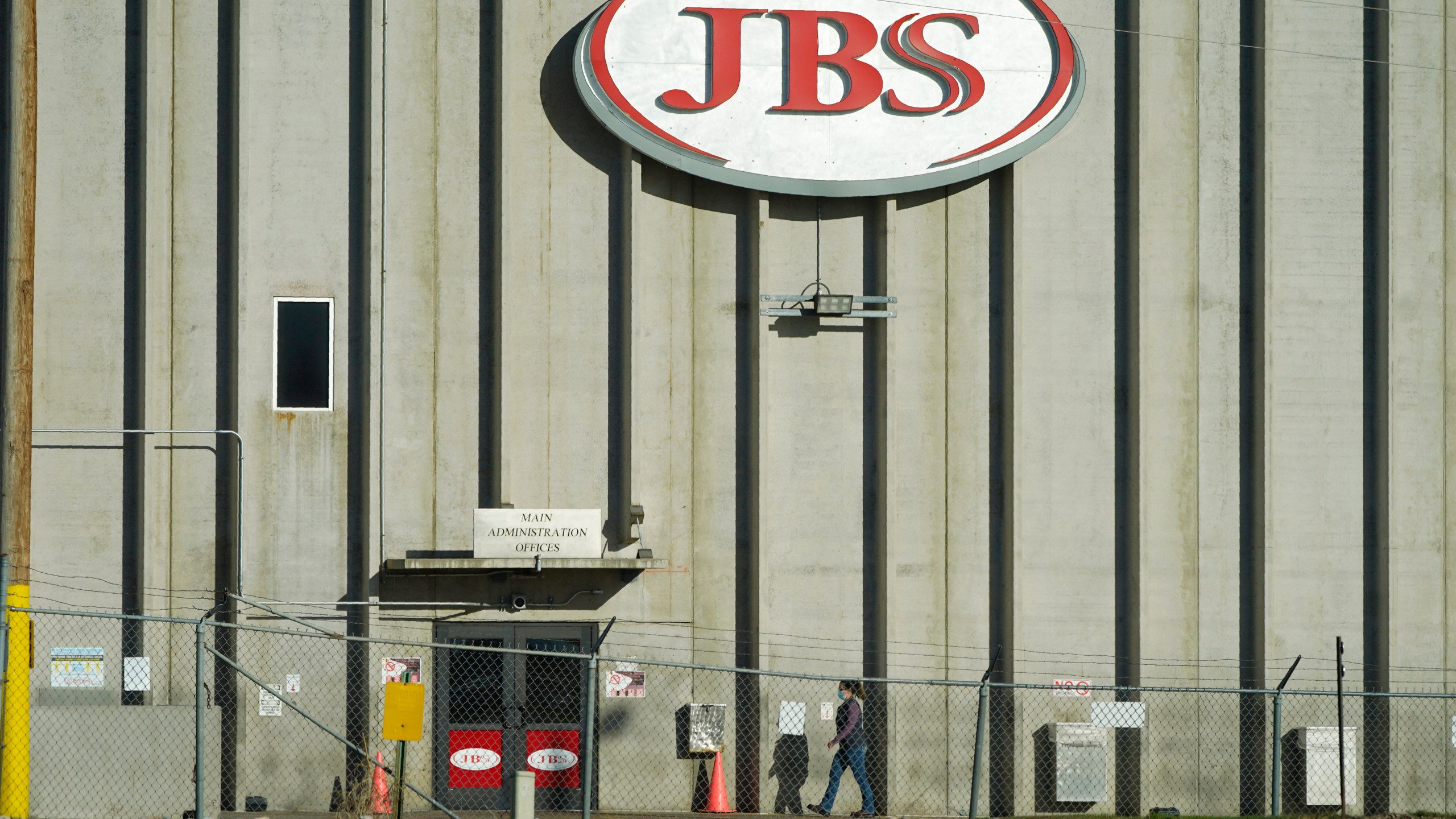 In this Oct. 12, 2020 file photo, a worker heads into the JBS meatpacking plant in Greeley, Colo. A weekend ransomware attack on the world’s largest meat company is disrupting production around the world just weeks after a similar incident shut down a U.S. oil pipeline. The White House confirms that Brazil-based meat processor JBS SA notified the U.S. government Sunday, May 30, 2021, of a ransom demand from a criminal organization likely based in Russia. (AP Photo/David Zalubowski, File)