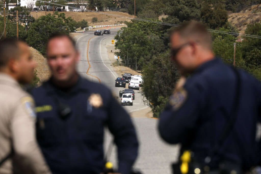 Law enforcement authorities close off a road during an investigation for a shooting at fire station 81 in Santa Clarita, Calif. on Tuesday, June 1, 2021. (AP Photo/David Swanson)