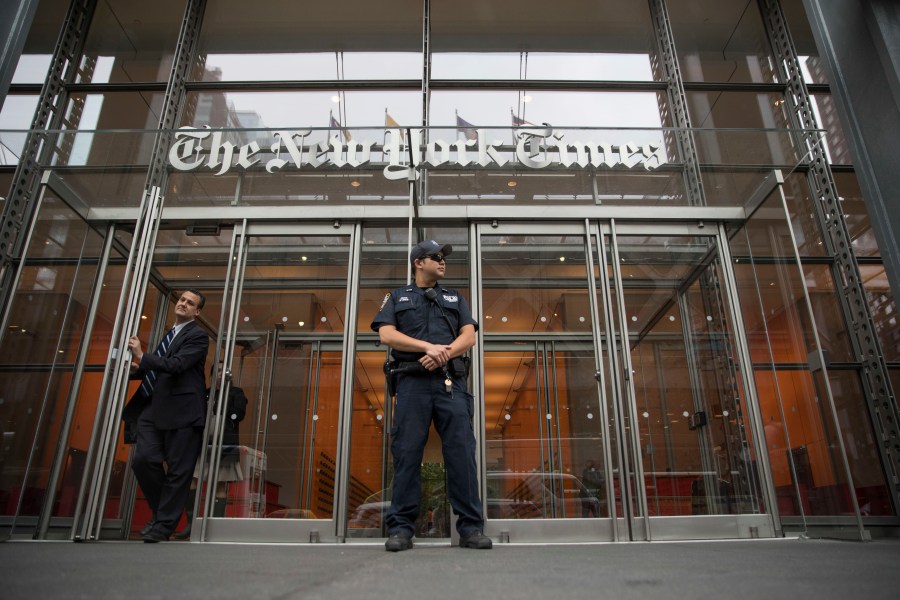 In this June 28, 2018, file photo, a police officer stands outside The New York Times building in New York. The Trump Justice Department secretly obtained the phone records of four New York Times journalists as part of a leak investigation, the newspaper said Wednesday, June 2, 2021. (AP Photo/Mary Altaffer, File)