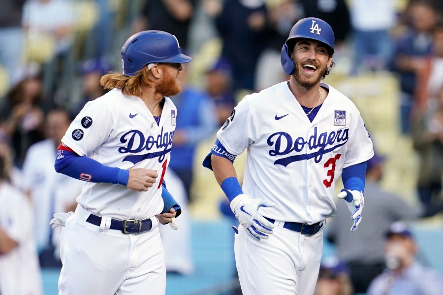 Los Angeles Dodgers' Cody Bellinger, right, smiles next to Justin Turner after Bellinger's grand slam against the St. Louis Cardinals during the first inning of a baseball game on June 2, 2021, in Los Angeles. (AP Photo/Marcio Jose Sanchez)