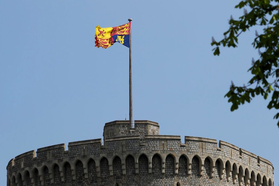 In this file photo dated Wednesday, April 21, 2021, The Royal Standard flies above Windsor Castle in Windsor, England. (AP Photo/Kirsty Wigglesworth, FILE)