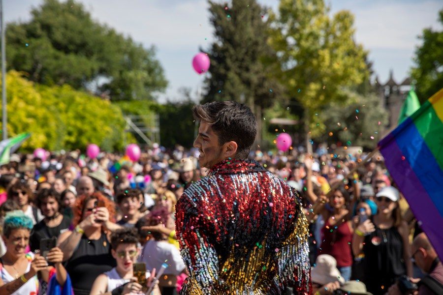 Participants dance in the annual Gay Pride parade in Jerusalem, Thursday, June 3, 2021. Thousands of people marched through the streets of Jerusalem on Thursday in the city's annual gay pride parade. (AP Photo/Ariel Schalit)