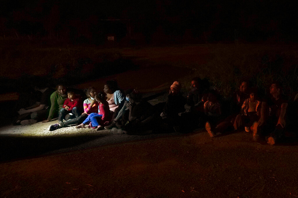 Migrants mainly from Honduras and Nicaragua sit in line after turning themselves in upon crossing the U.S.-Mexico border Monday, May 17, 2021, in La Joya, Texas. (AP Photo/Gregory Bull, file)