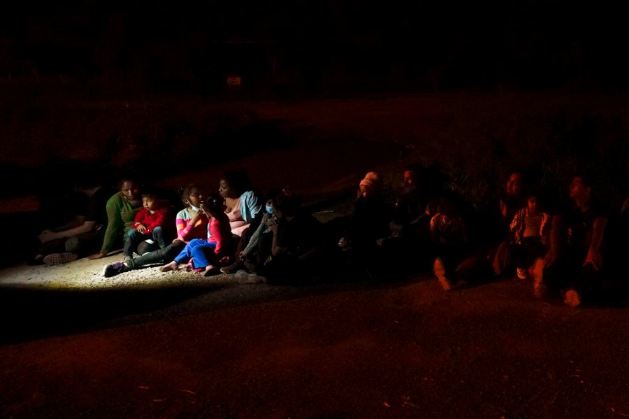 Migrants mainly from Honduras and Nicaragua sit in line after turning themselves in upon crossing the U.S.-Mexico border Monday, May 17, 2021, in La Joya, Texas. (AP Photo/Gregory Bull, file)