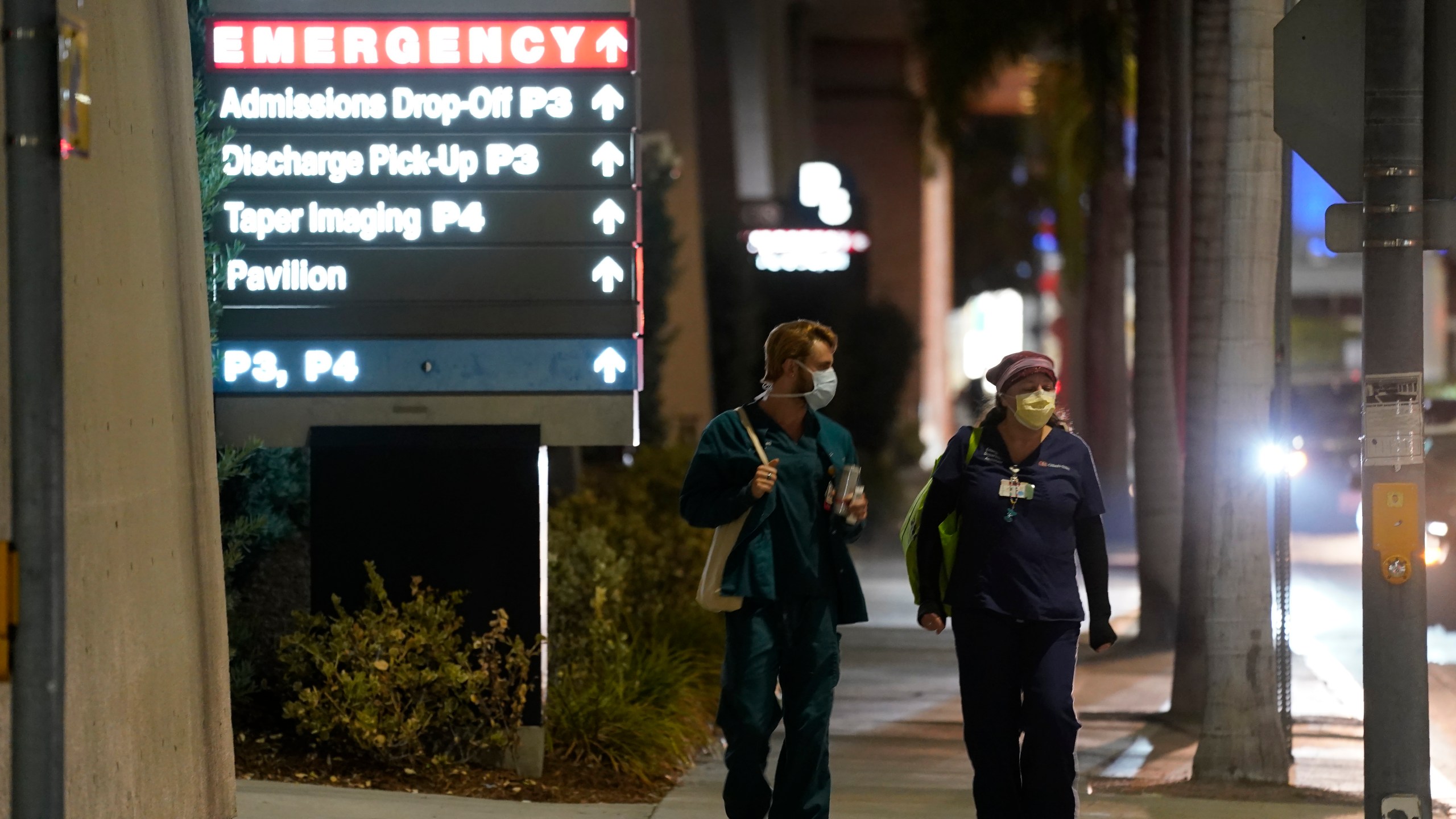 In this Jan. 5, 2021, file photo, Cedars-Sinai Medical Center workers walk outside the hospital, in Los Angeles. The California Senate has rejected a bill aimed at making it easier for some hospital workers to get workers compensation benefits. (AP Photo/Chris Pizzello,File)