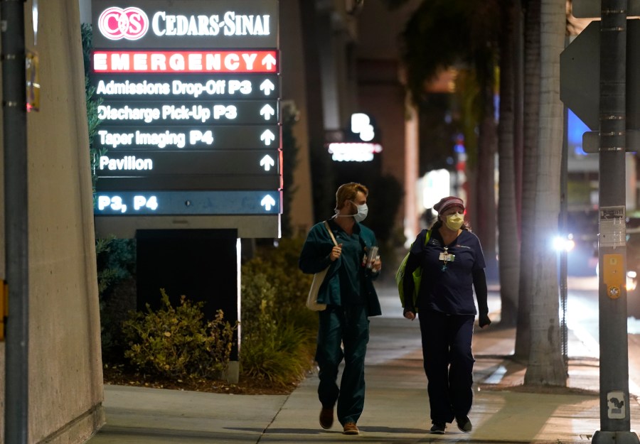 In this Jan. 5, 2021, file photo, Cedars-Sinai Medical Center workers walk outside the hospital, in Los Angeles. The California Senate has rejected a bill aimed at making it easier for some hospital workers to get workers compensation benefits. (AP Photo/Chris Pizzello,File)