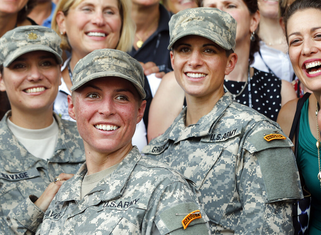 In this Aug. 21, 2015, file photo, Army 1st Lt. Shaye Haver, center, and Capt. Kristen Griest, right, pose for photos with other female West Point alumni after an Army Ranger school graduation ceremony at Fort Benning, Ga. Haver and Griest became the first female graduates of the Army's rigorous Ranger School. (AP Photo/John Bazemore, File)