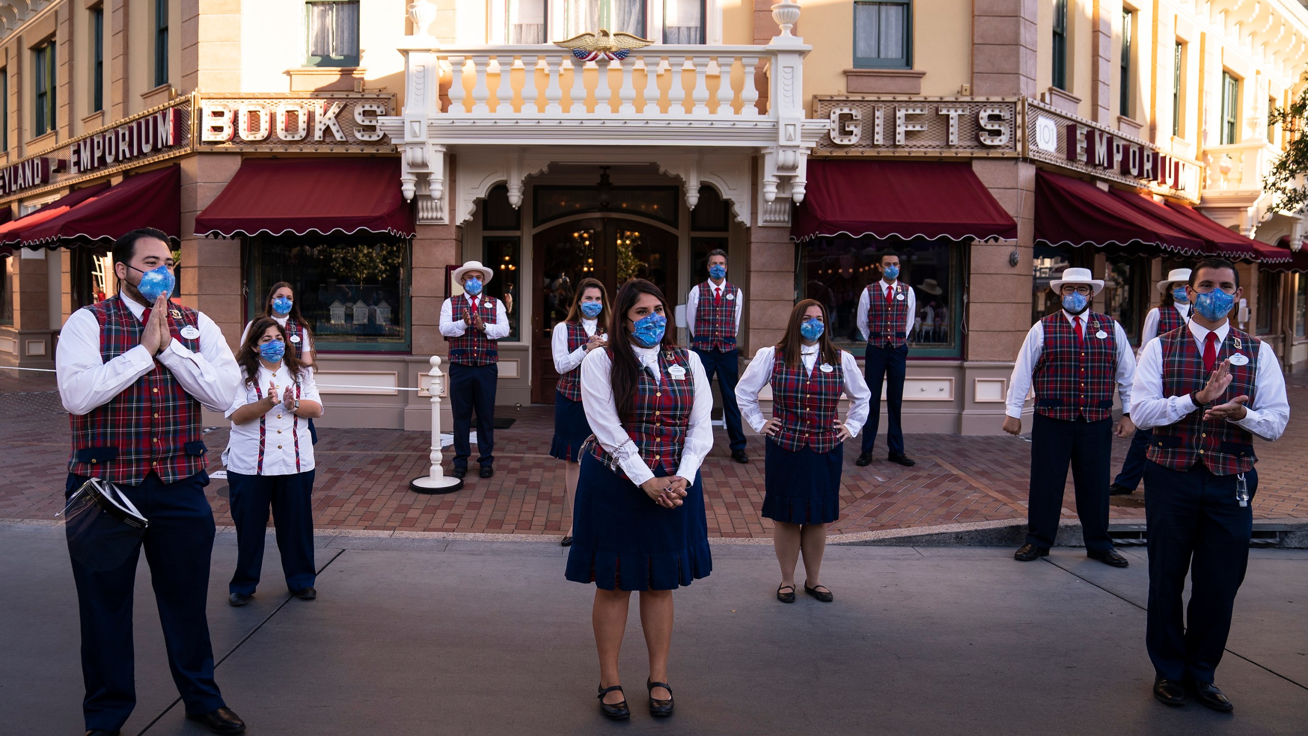 In this April 30, 2021, file photo, employees stand socially distanced during a meeting at Disneyland in Anaheim. (AP Photo/Jae C. Hong, File)