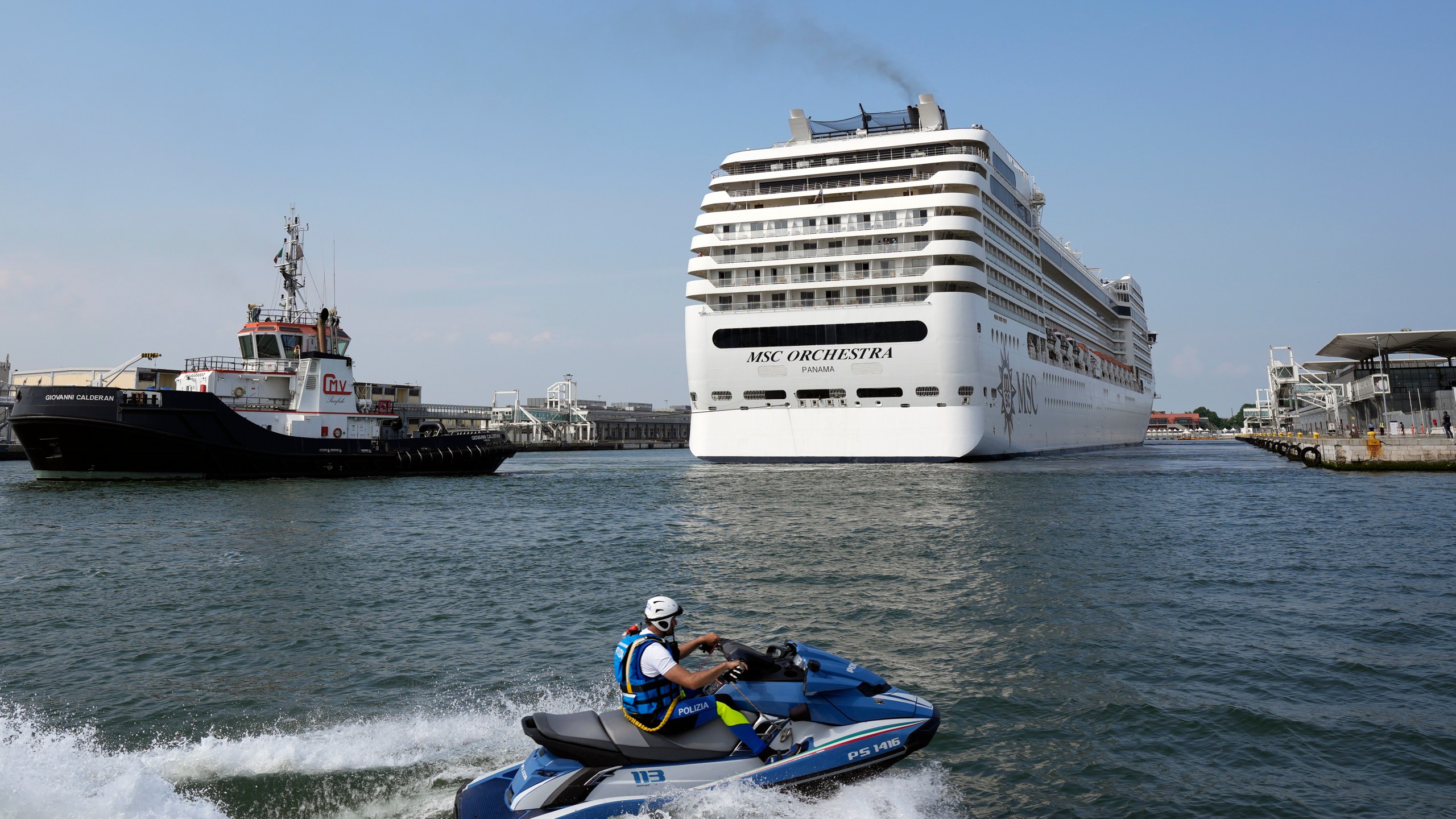 The the 92,409-ton, 16-deck MSC Orchestra cruise ship exits the lagoon as it leaves Venice, Italy, Saturday, June 5, 2021. (AP Photo/Antonio Calanni)