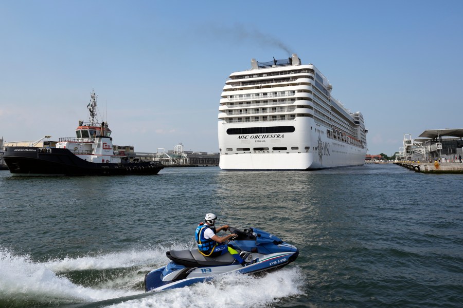 The the 92,409-ton, 16-deck MSC Orchestra cruise ship exits the lagoon as it leaves Venice, Italy, Saturday, June 5, 2021. (AP Photo/Antonio Calanni)