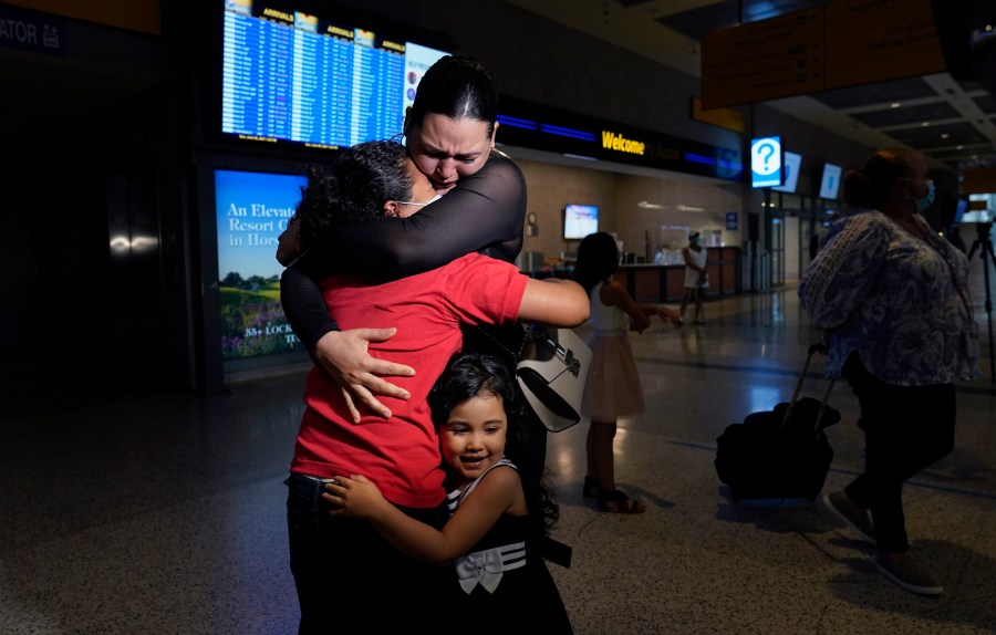 Emely, left, is reunited with her mother, Glenda Valdez and sister, Zuri, at Austin-Bergstrom International Airport, Sunday, June 6, 2021, in Austin, Texas. It had been six years since Valdez said goodbye to her daughter Emely in Honduras. Then, last month, she caught a glimpse of a televised Associated Press photo of a little girl in a red hoodie and knew that Emely had made the trip alone into the United States. On Sunday, the child was returned to her mother’s custody. (AP Photo/Eric Gay)