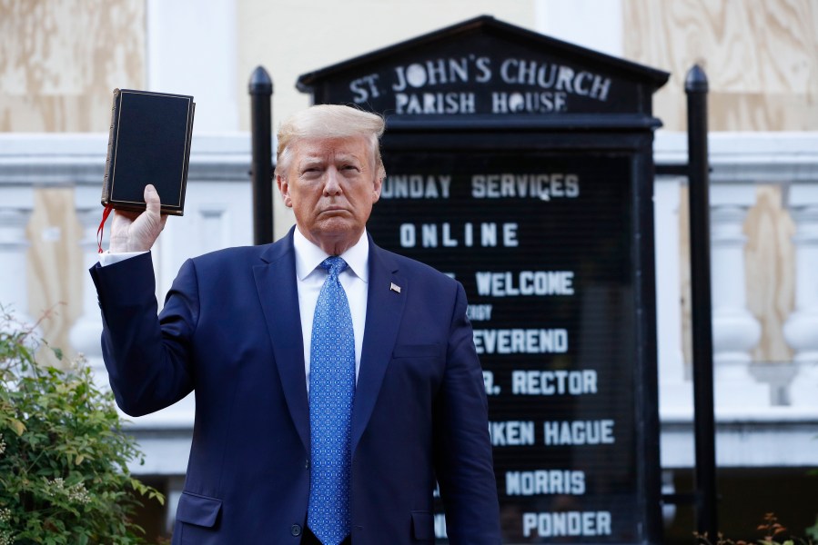 In this June 1, 2020, file photo President Donald Trump holds a Bible as he visits outside St. John's Church across Lafayette Park from the White House in Washington. An internal investigation has determined that the decision to clear racial justice protestors from an area in front of the White House last summer was not influenced by then-President Donald Trump’s plans for a photo opportunity at that spot. The report released Wednesday by the Department of Interior’s Inspector General concludes that the protestors were cleared by U.S. Park Police on June 1 of last year so new fencing could be installed. (AP Photo/Patrick Semansky, File)