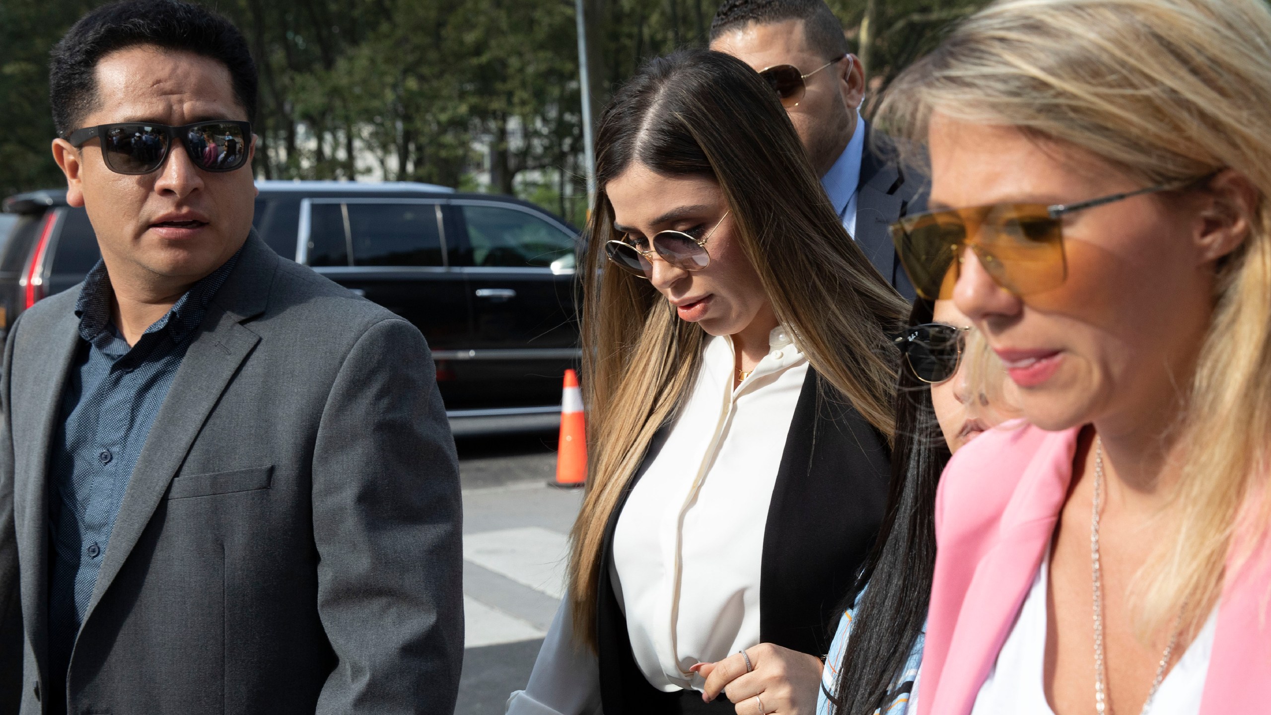 In this July 17, 2019 file photo, Emma Coronel Aispuro, center, wife of Mexican drug lord Joaquin "El Chapo" Guzman, arrives for his sentencing at Brooklyn federal court, in New York. Emma Coronel Aispuro is expected to plead guilty to federal criminal charges after she had been charged in the U.S. with helping her husband run his multibillion-dollar criminal empire. She is due in court Thursday, June 10, 2021, in Washington for a plea agreement hearing, according to court records. (AP Photo/Mark Lennihan, File)