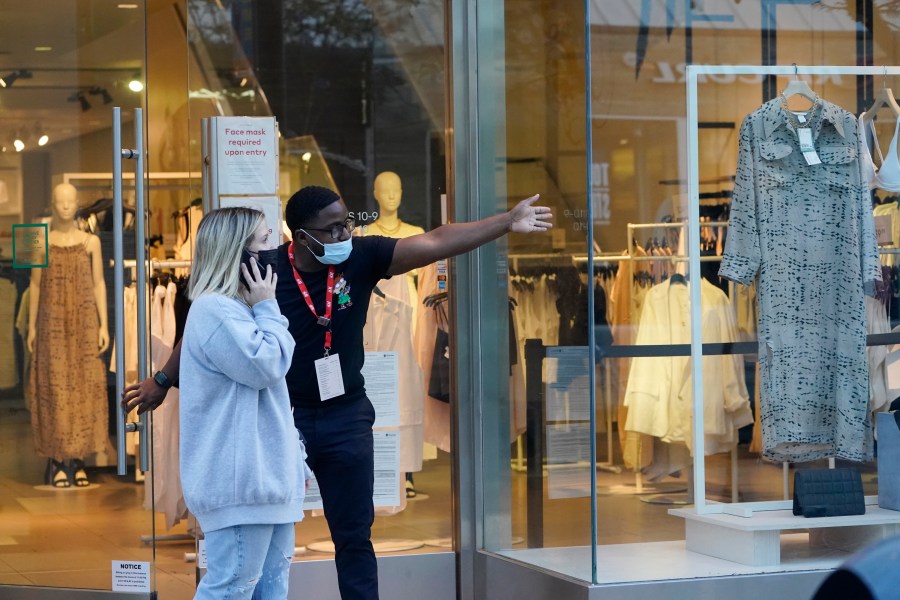 A salesperson gives directions to a shopper amid the COVID-19 pandemic on The Promenade Wednesday, June 9, 2021, in Santa Monica, Calif. (AP Photo/Marcio Jose Sanchez)