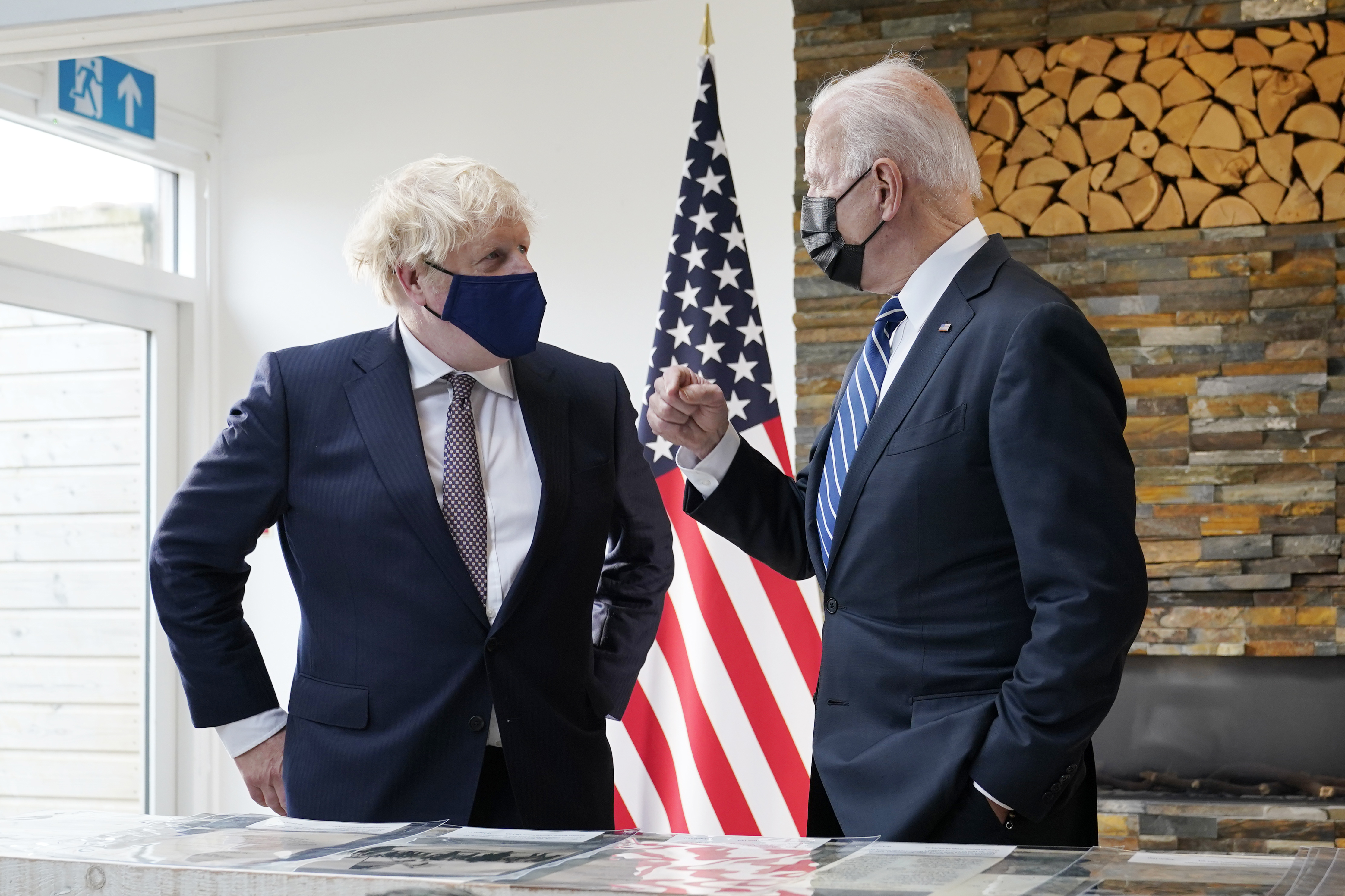 President Joe Biden and British Prime Minister Boris Johnson talk as they look over copies of the Atlantic Charter, during a bilateral meeting ahead of the G-7 summit, Thursday, June 10, 2021, in Carbis Bay, England.The Atlantic Charter is a copy of the original 1941 statement signed by FDR and Winston Churchill. (AP Photo/Patrick Semansky)