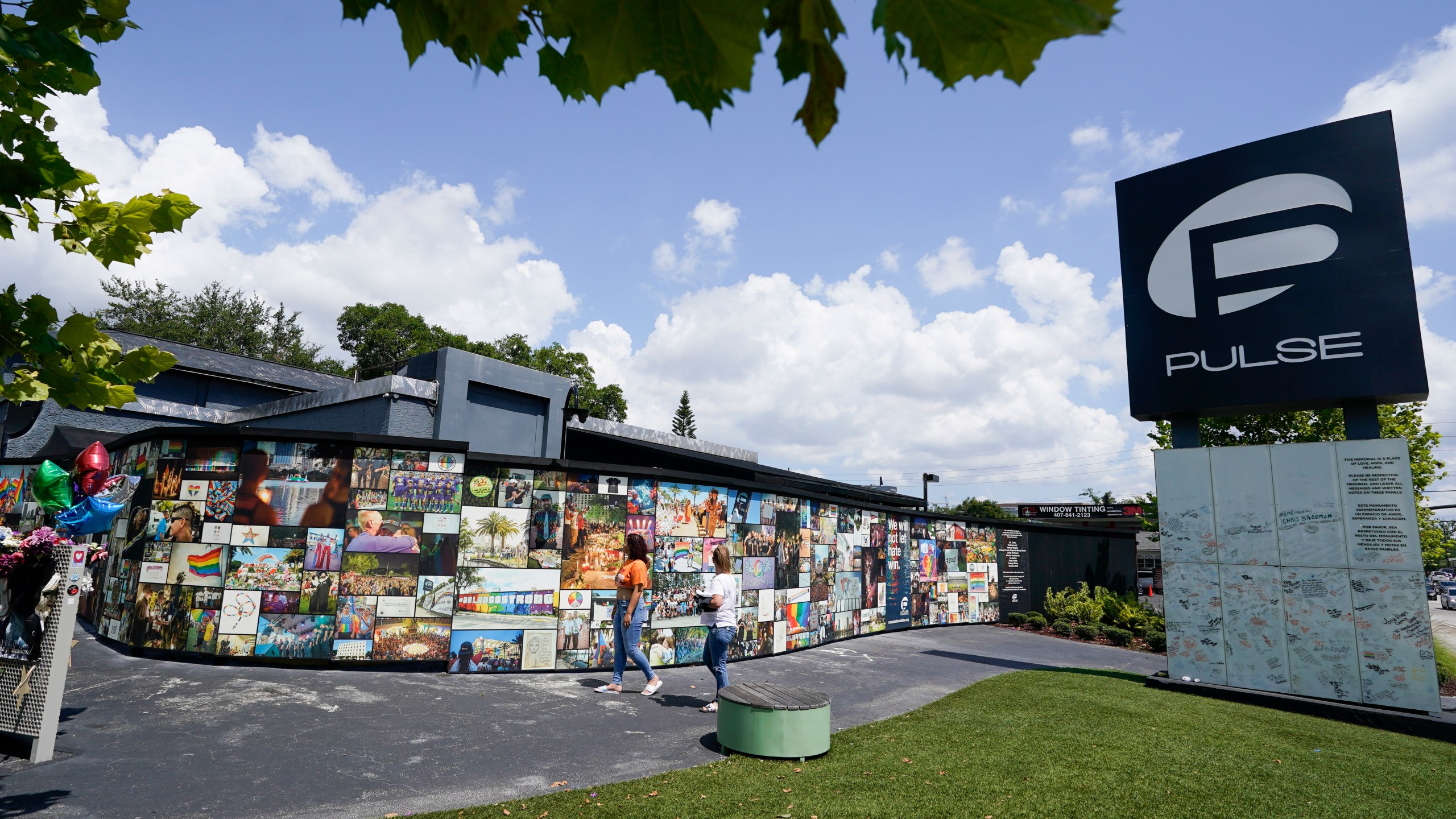 Visitors pay tribute to the display outside the Pulse nightclub memorial Friday, June 11, 2021, in Orlando, Fla. Saturday will mark the fifth anniversary of the mass shooting at the site. (AP Photo/John Raoux)