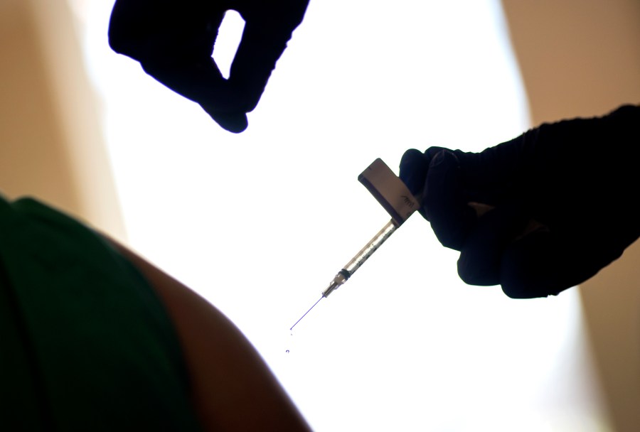 In this Tuesday, Dec. 15, 2020 file photo, a droplet falls from a syringe after a health care worker was injected with the Pfizer-BioNTech COVID-19 vaccine at a hospital in Providence, R.I. (AP Photo/David Goldman, File)