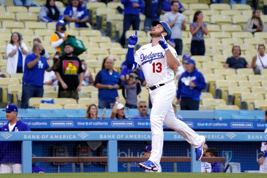 Los Angeles Dodgers' Max Muncy gestures before scoring after hitting a two-run home run during the first inning of a baseball game against the Texas Rangers Friday, June 11, 2021, in Los Angeles. (AP Photo/Mark J. Terrill)