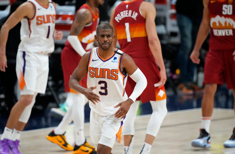 Phoenix Suns guard Chris Paul, front, reacts after hitting a basket late in the second half of Game 4 of an NBA second-round playoff series against the Denver Nuggets, Sunday, June 13, 2021, in Denver. (AP Photo/David Zalubowski)