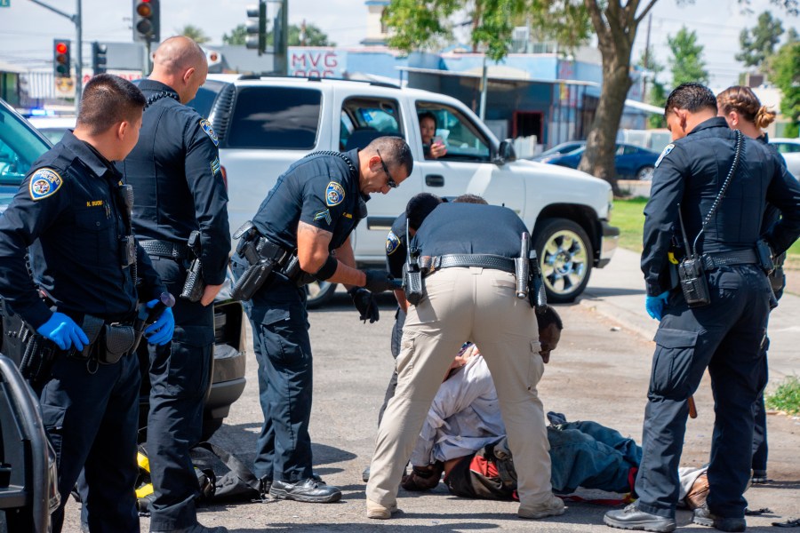 In this Friday, May 21, 2021, photo, Bakersfield Police Department officers respond to an incident at Martin Luther King Jr. Park in southeast Bakersfield, Calif. (Anne Daugherty/California Reporting Project via AP)