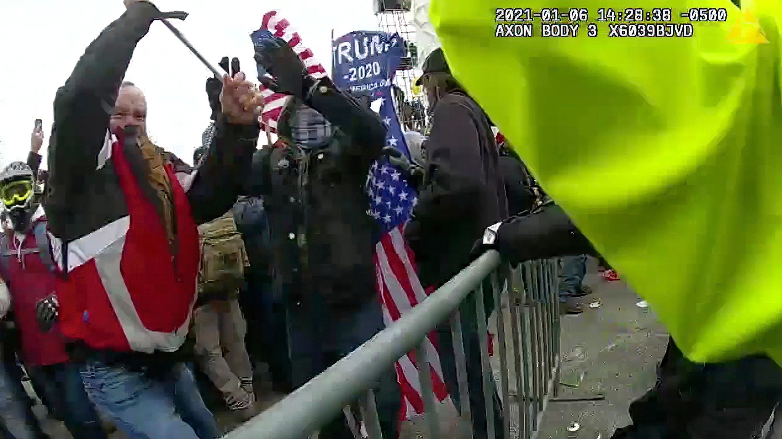 This still frame from Metropolitan Police Department body worn camera video shows Thomas Webster, in red jacket, at a barricade line at on the west front of the U.S. Capitol on Jan. 6, 2021, in Washington. (Metropolitan Police Department via Associated Press)