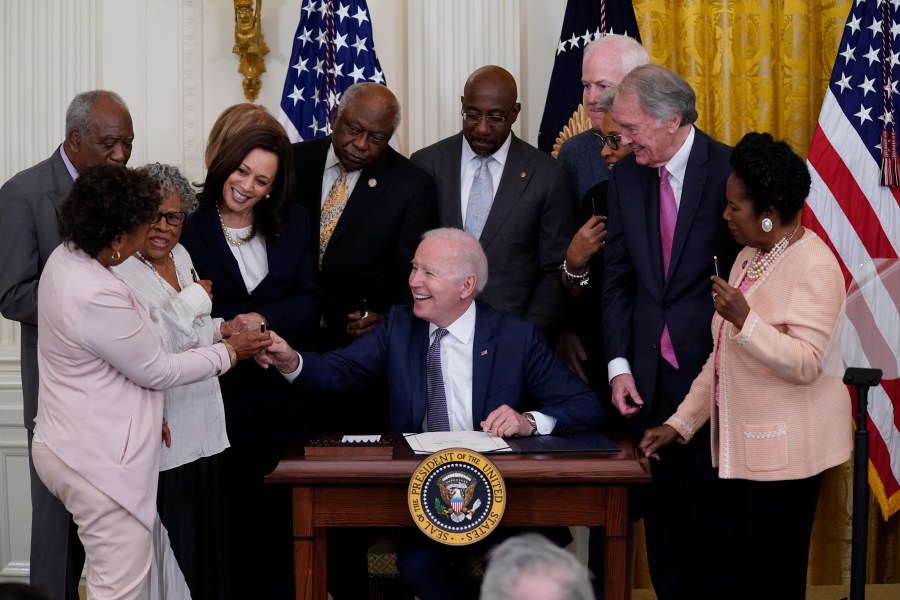 In this June 17, 2021, file photo, President Joe Biden hands a pen to Rep. Barbara Lee, D-Calif., after signing the Juneteenth National Independence Day Act, in the East Room of the White House in Washington. From left, Rep. Barbara Lee, D-Calif, Rep. Danny Davis, D-Ill., Opal Lee, Sen. Tina Smith, D-Minn., obscured, Vice President Kamala Harris, House Majority Whip James Clyburn of S.C., Sen. Raphael Warnock, D-Ga., Sen. John Cornyn, R-Texas, Rep. Joyce Beatty, D-Ohio, obscured, Sen. Ed Markey, D-Mass., and Rep. Sheila Jackson Lee, D-Texas. (AP Photo/Evan Vucci, File)