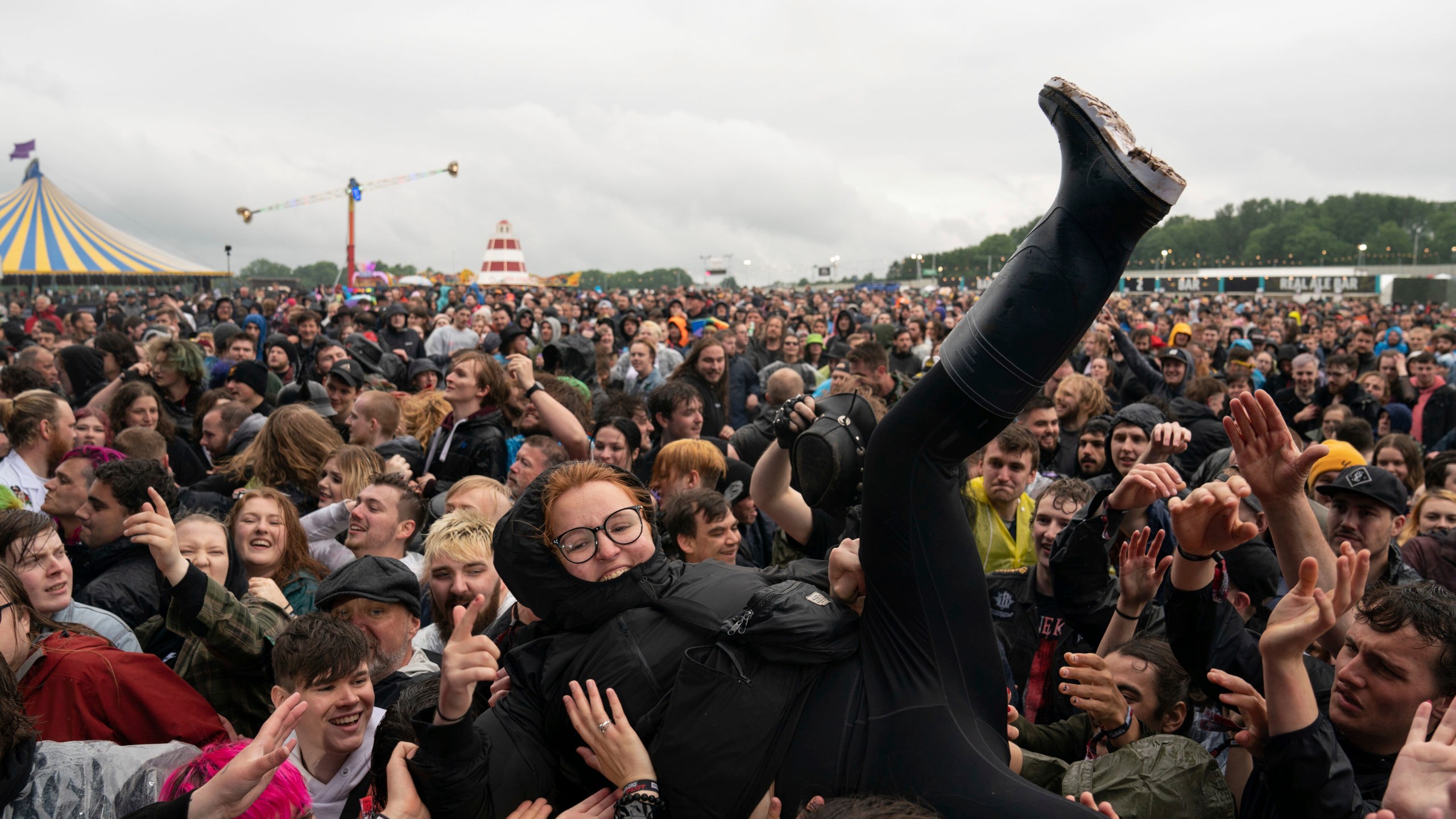 A festivalgoer crowd surfs on the first day of Download Festival at Donington Park at Castle Donington, England, Friday June 18, 2021. The three-day music and arts festival is being held as a test event to examine how Covid-19 transmission takes place in crowds, with the the capacity significantly reduced from the normal numbers. (Joe Giddens/( /PA via AP)