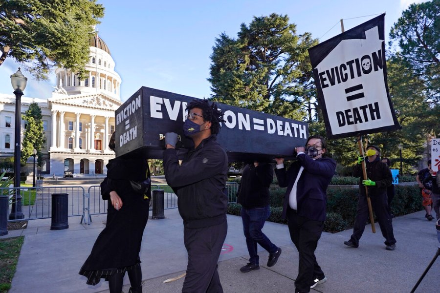 In this Jan. 25, 2021, file photo, demonstrators call passage of rent forgiveness and stronger eviction protections legislation and carry a mock casket past the Capitol in Sacramento, Calif. (AP Photo/Rich Pedroncelli, File)