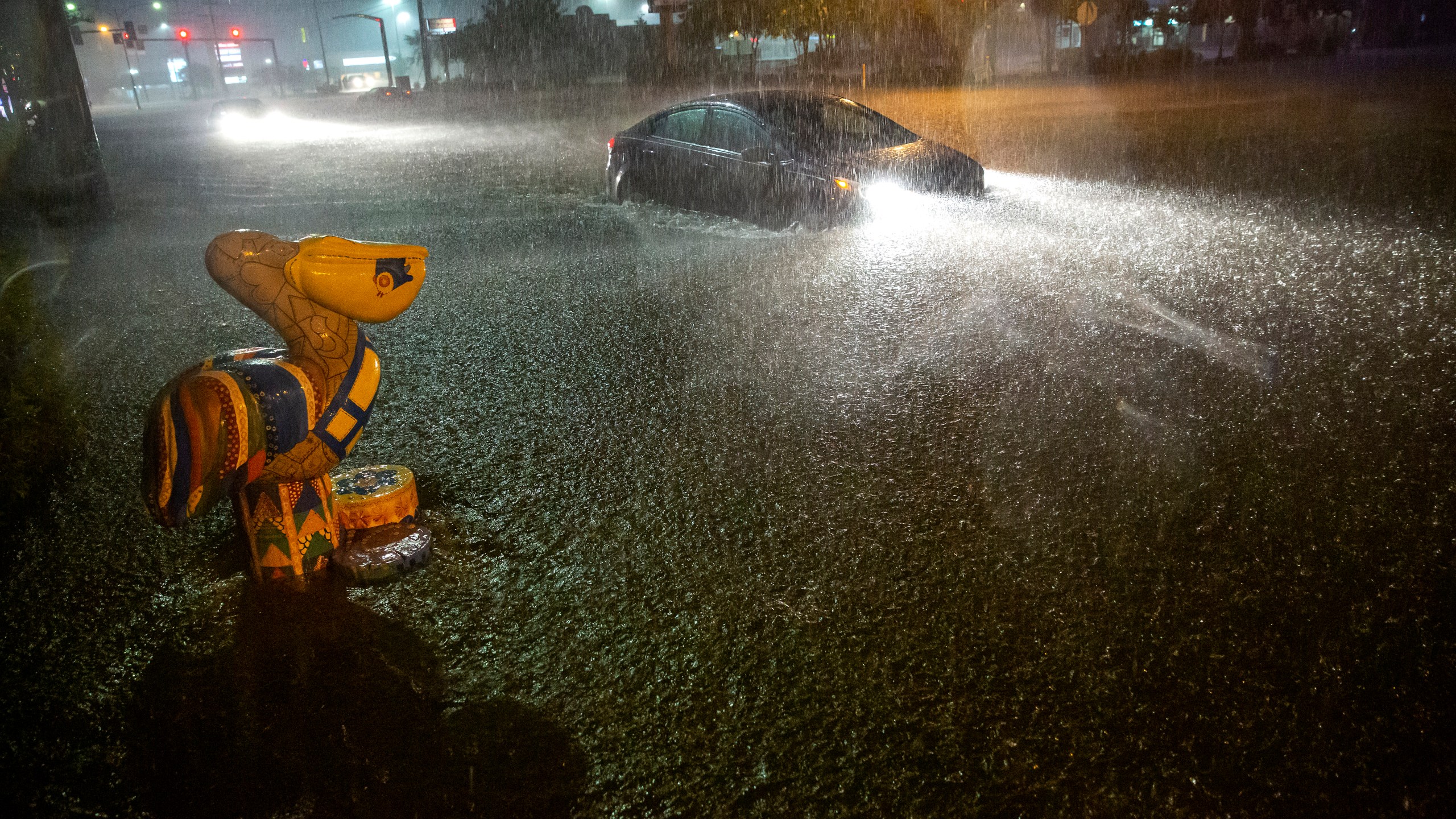 Motorists navigate a flooded Gause Boulevard in Slidell, La., late Friday, June 18, 2021, as a tropical disturbance neared the Louisiana shore. (Scott Threlkeld/The Advocate via AP)