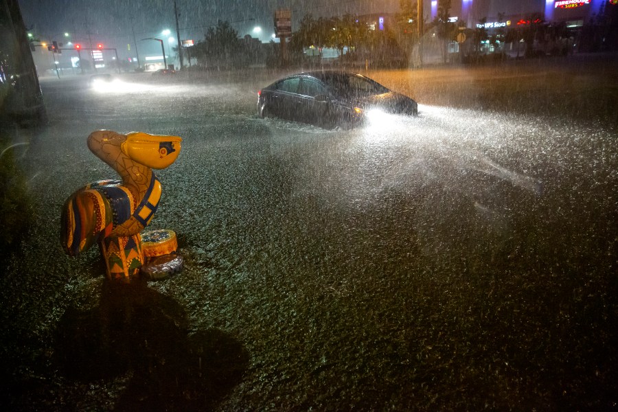 Motorists navigate a flooded Gause Boulevard in Slidell, La., late Friday, June 18, 2021, as a tropical disturbance neared the Louisiana shore. (Scott Threlkeld/The Advocate via AP)