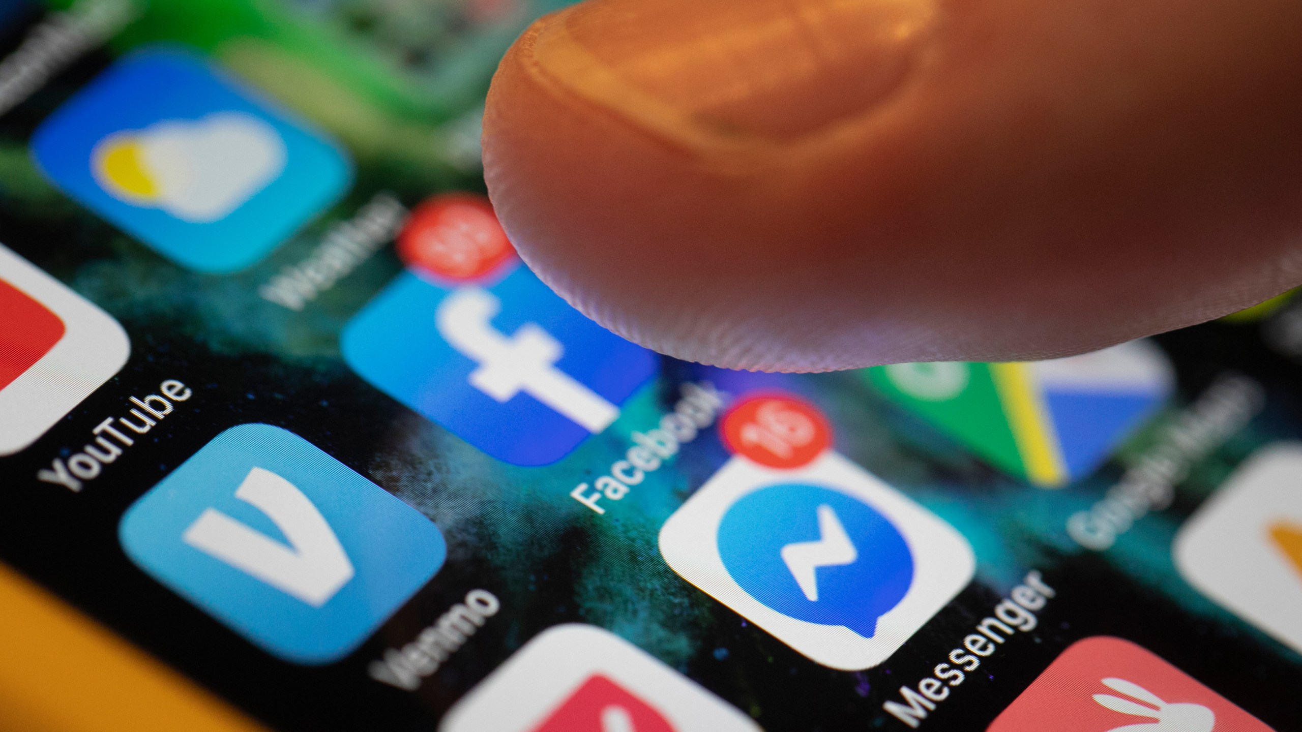 This Aug. 11, 2019, file photo an iPhone displays the apps for Facebook and Messenger in New Orleans. (AP Photo/Jenny Kane, File)